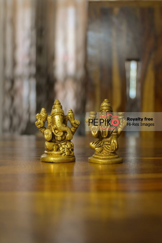 
									Close up of Lord Ganesh and Devi Laxmi small statues on festival celebrations.