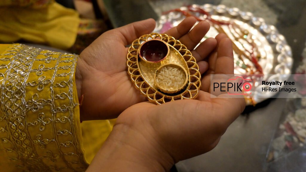Decorative mini tray for dry fruits in small hands of girl child