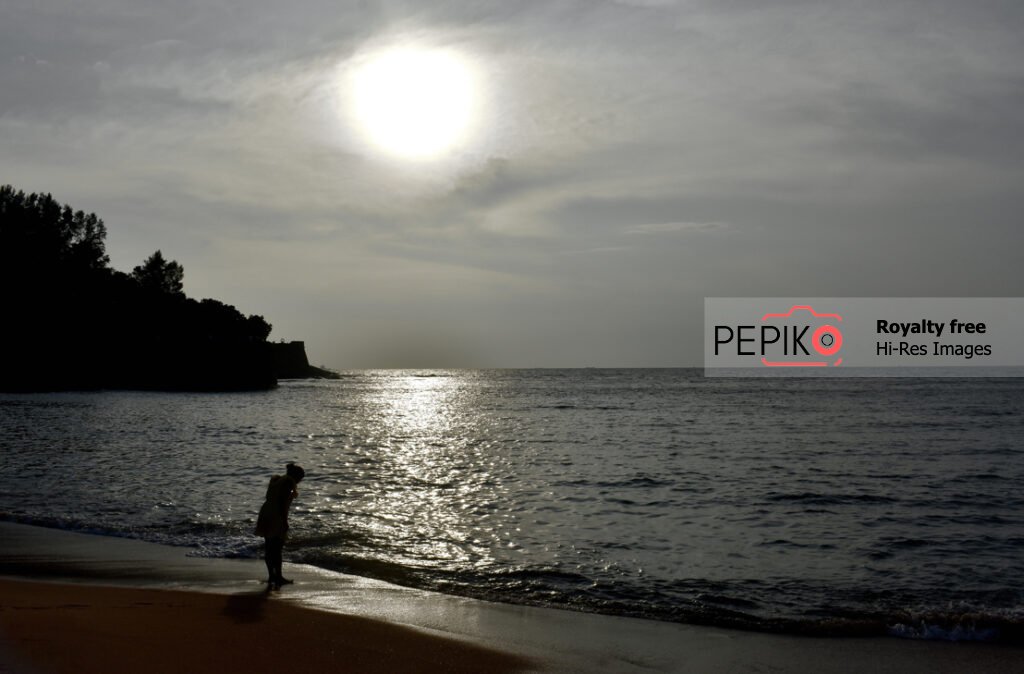 Photo of young women traveler in GOA in India enjoying at water sand beach