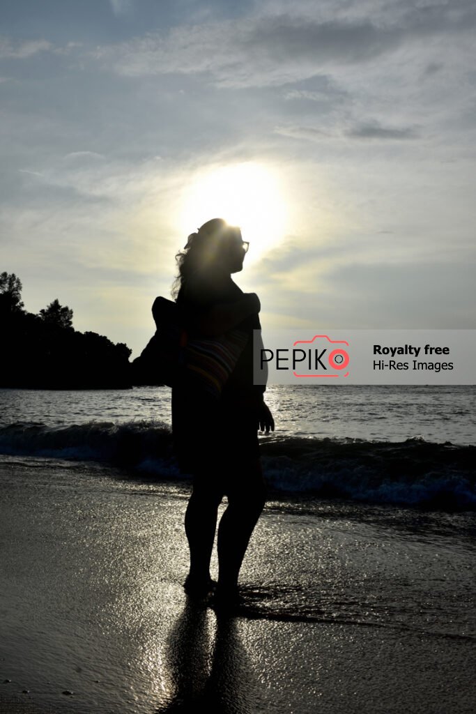 Beautiful photo of young women traveler in GOA in India enjoying at water sand beach