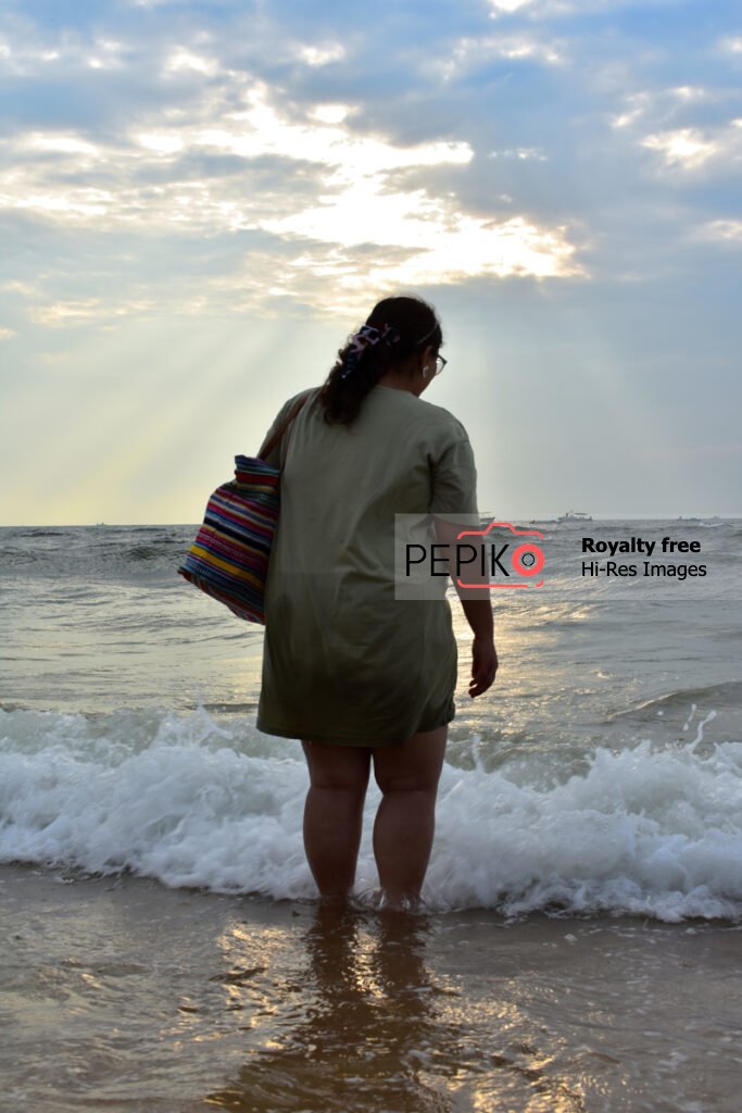Young lady with her handbag enjoying in GOA India