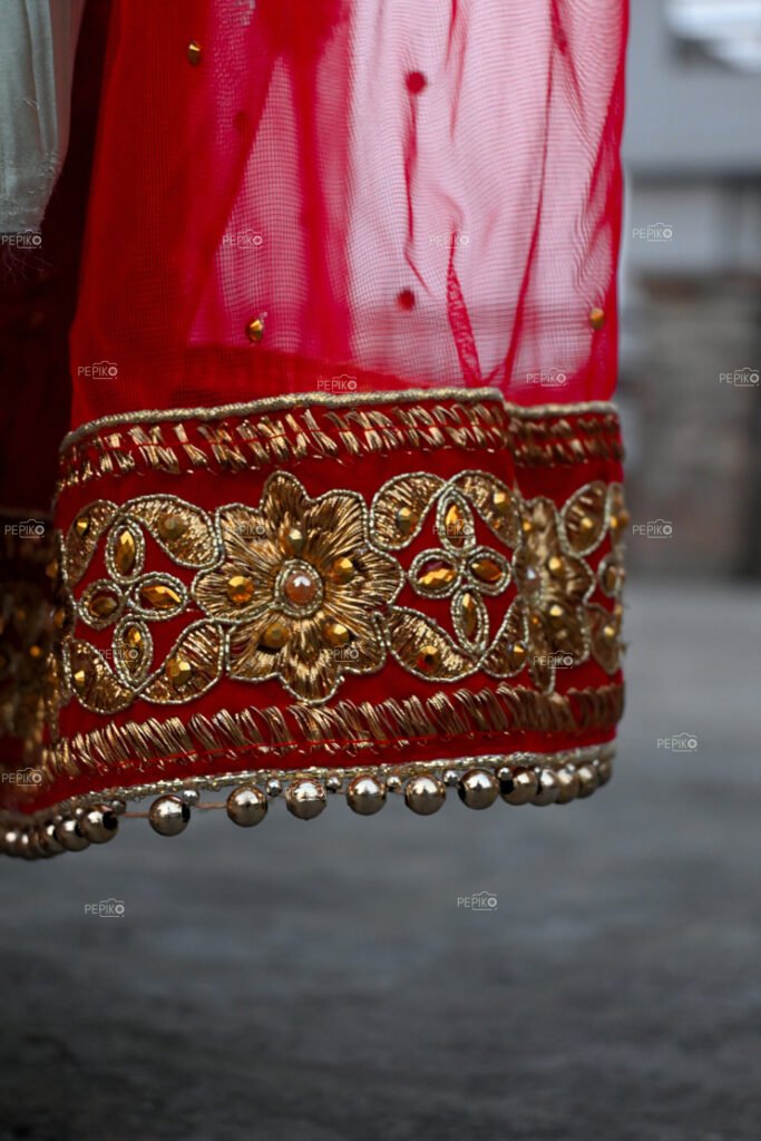 
									Picture of gown border made of red and golden silk thread