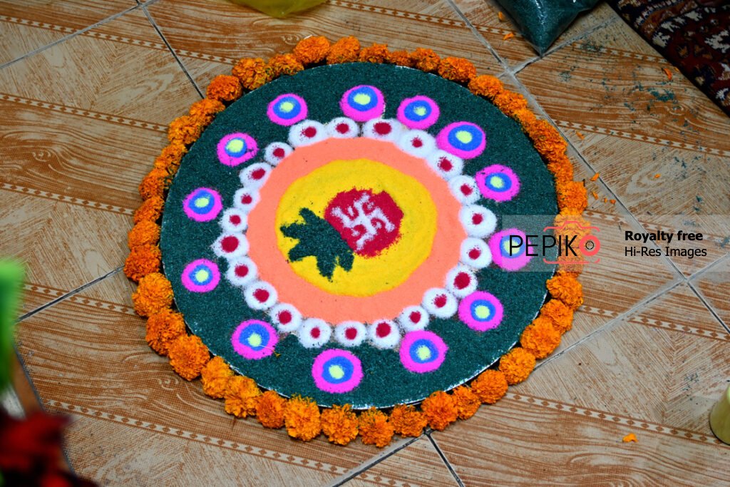 Beautiful rangoli being prepared on festival with vibrant colours