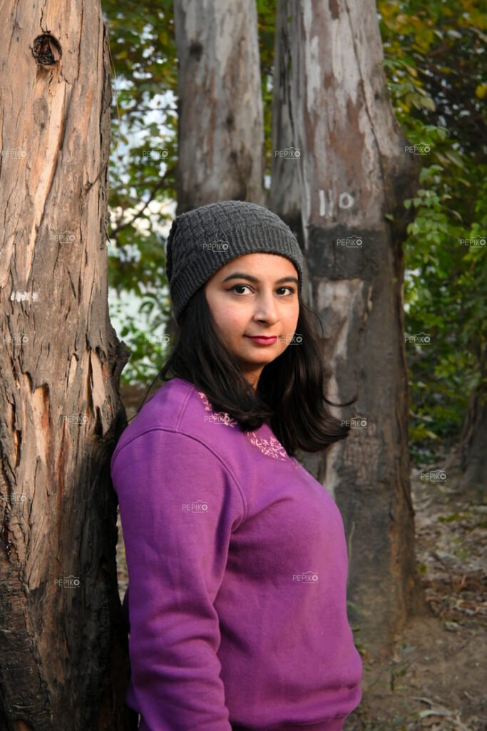 Portrait of a girl with tree besides