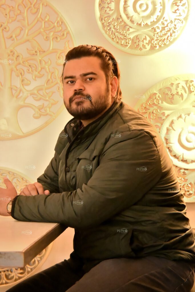 Portrait of an Indian man in green jacket during winter