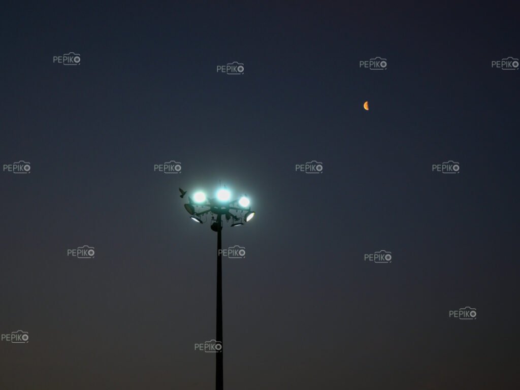 Street light with little moon by its side